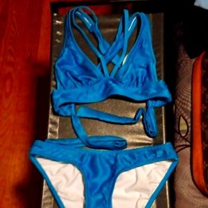 Nwot Never worn aqua color bikini criss cross in back with adjustable tie